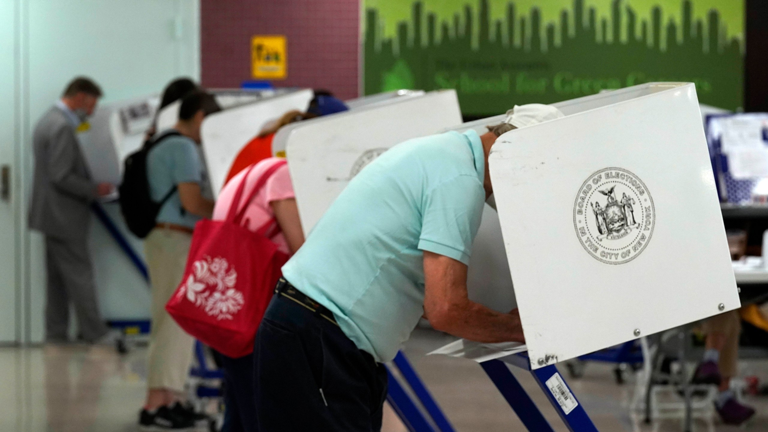 Voters mark their ballots at Frank McCourt High School, in New York, on June 22, 2021. (Richard Drew/Associated Press)