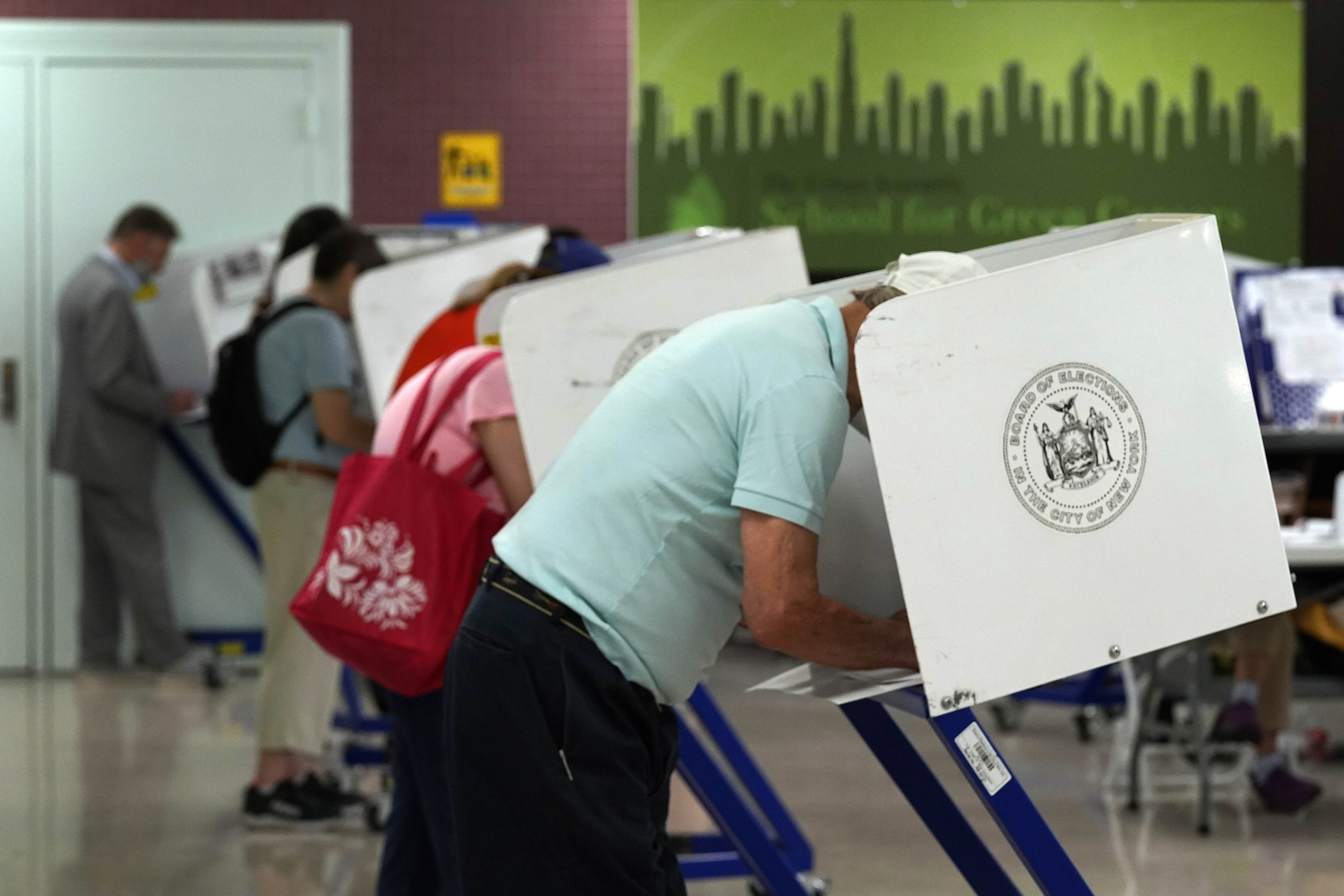 Voters mark their ballots at Frank McCourt High School, in New York, on June 22, 2021. (Richard Drew/Associated Press)