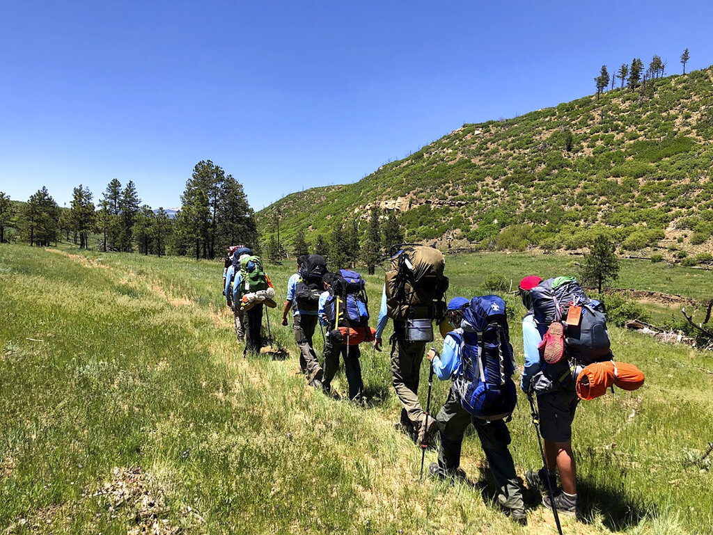 In this June 10, 2021 photo provided by Barry Bedlan, members of Troop 298 of Frisco, Texas are among the first to embark a 12-day trek across the Philmont Scout Ranch, outside Cimarron, N.M. (Barry Bedlan via AP)