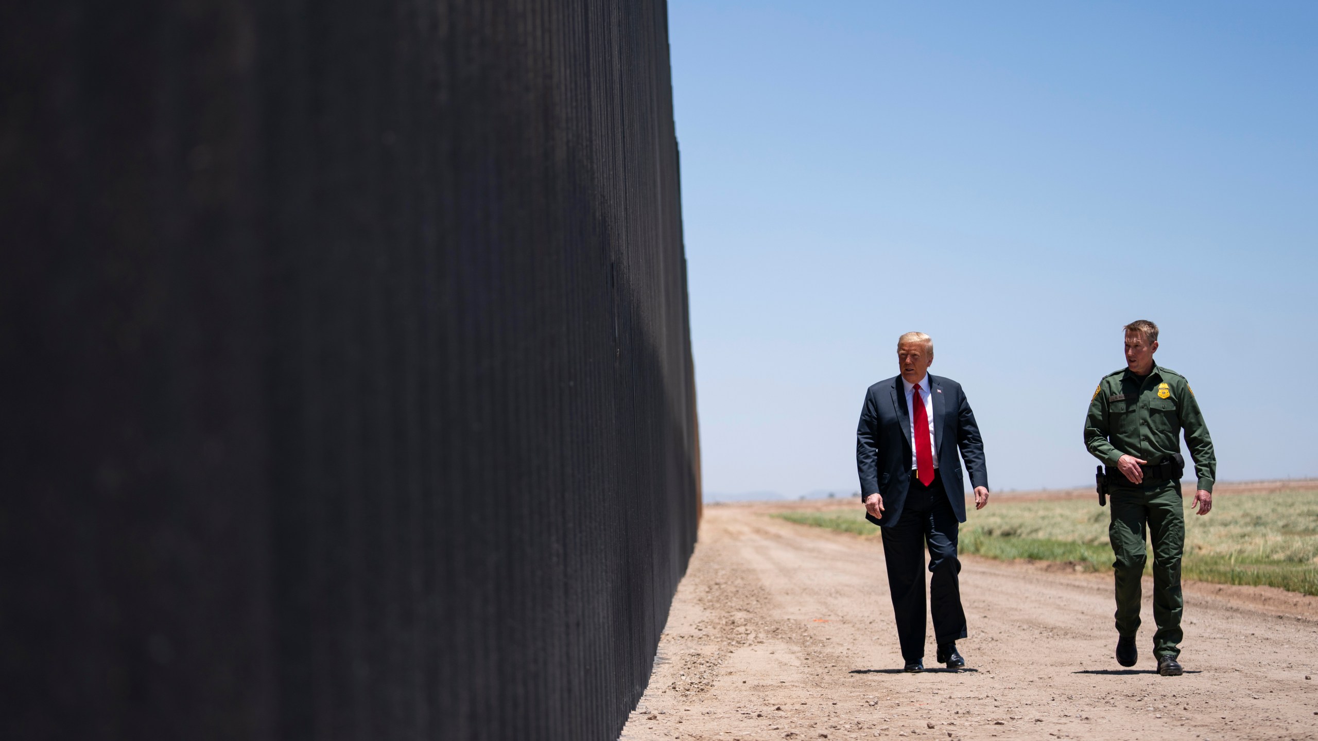 In this June 23, 2020 file photo, U.S. Border Patrol chief Rodney Scott gives President Donald Trump a tour of a section of the border wall in San Luis, Ariz. (Evan Vucci/Associated Press)