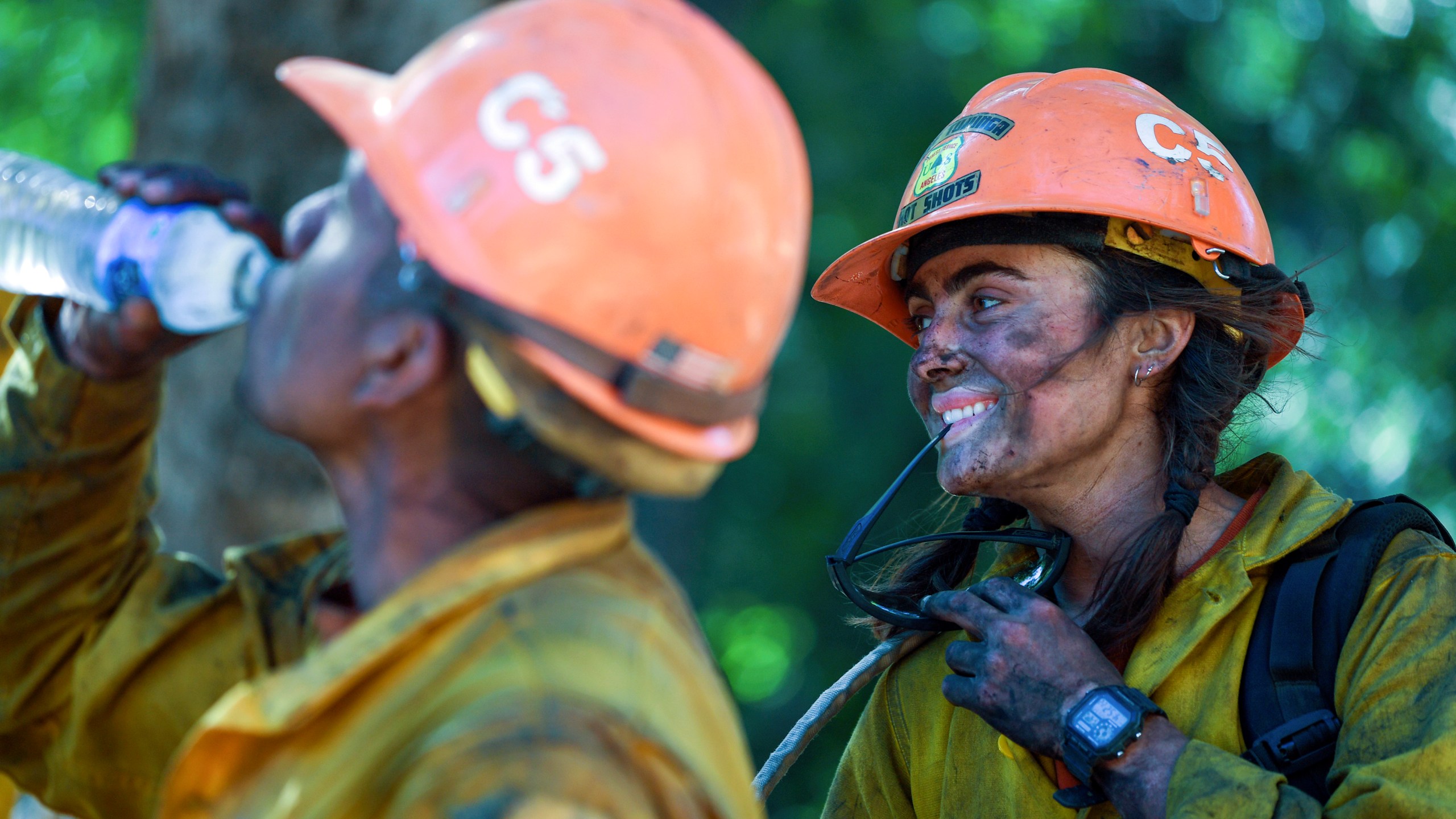 Members of the Little Tujunga Hot Shots take a break after fighting the Willow Fire near the Tassajara Zen Mountain Center in Carmel Valley, Calif., Wednesday, June 23, 2021. (AP Photo/Nic Coury)