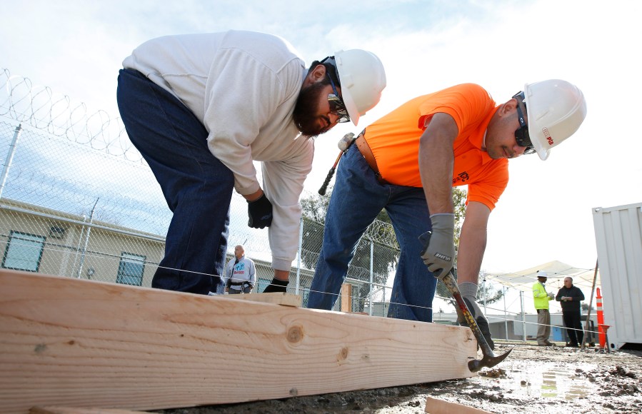 In this Jan. 22, 2019, file photo, youthful offenders Siegmond Navar, left and Gabriel Andalon construct a frame to hold concrete at one of the vocational classes at the O.H. Close Youth Correctional Facility, in Stockton, Calif. California is phasing out its state-run youth prisons and shifting the responsibilities to the counties. The state will not only keep offenders closers to home but transfer oversight form the corrections department to the Health and Human Services Agency. The three remaining state-run lockups, including there O.H Close Youth Correctional Facility, will stop admissions Thursday, July 1 and close for good two years later. (AP Photo/Rich Pedroncelli, File)