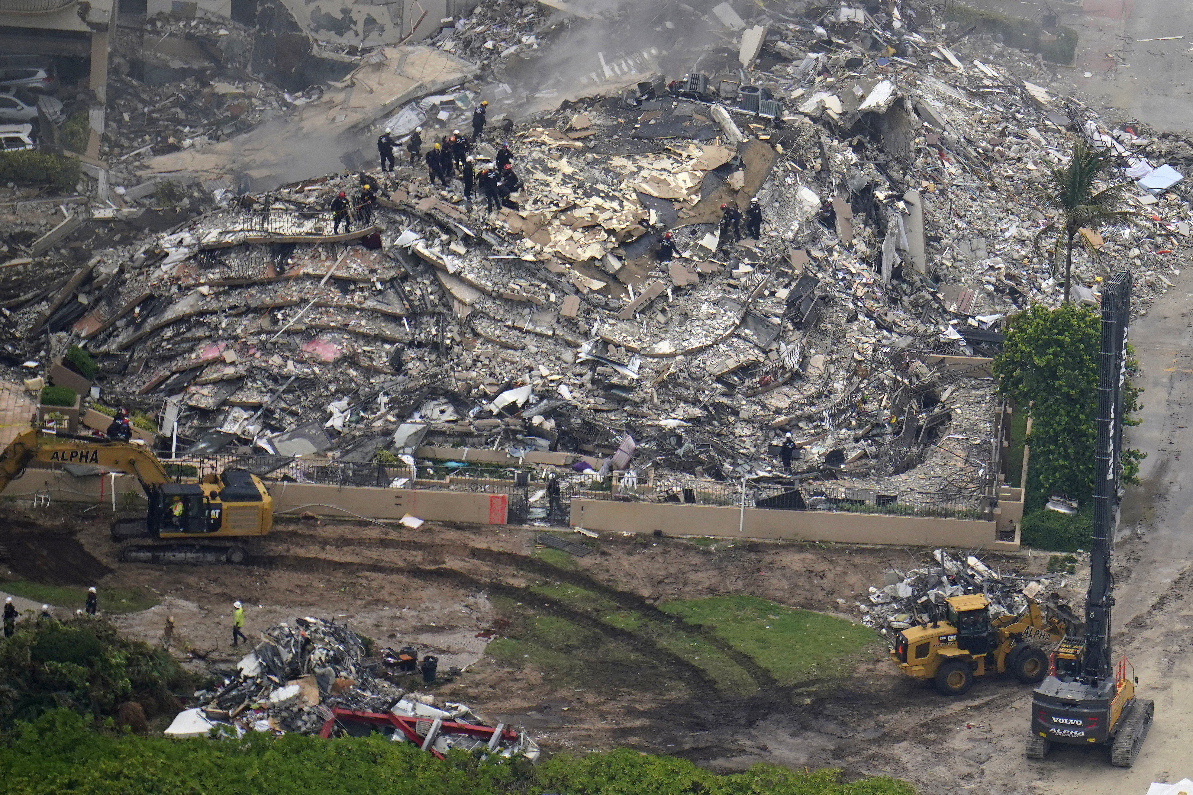 In this aerial image search and rescue workers work the site of an oceanfront condo building that partially collapsed, in Surfside, Fla., Friday, June 25, 2021. (AP Photo/Gerald Herbert)