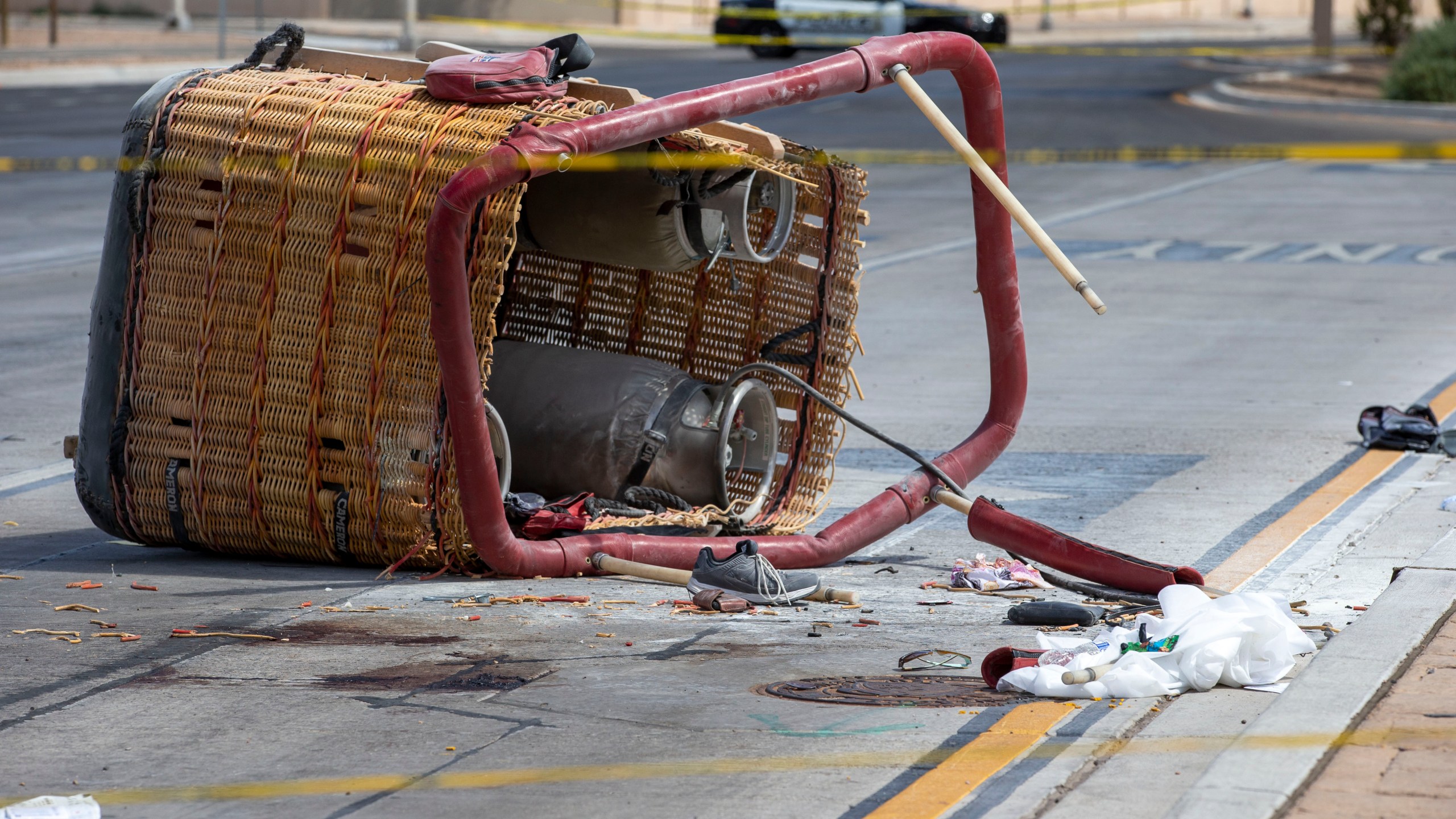 The basket of a hot air balloon which crashed lies on the pavement in Albuquerque, N.M., Saturday, June 26, 2021. Police said the five occupants died after it crashed on the busy street. (AP Photo/Andres Leighton)