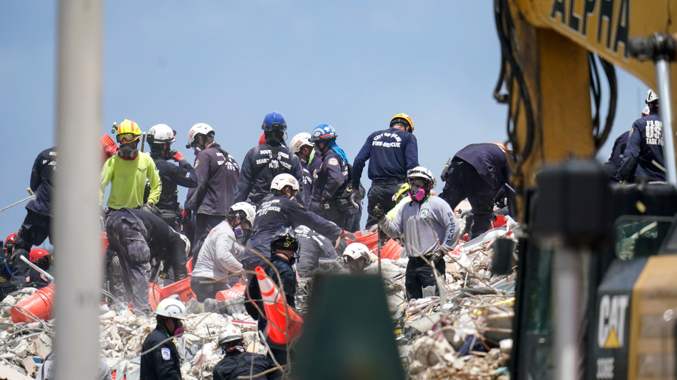 Workers search the rubble at the Champlain Towers South condo, Monday, June 28, 2021, in Surfside, Fla. Many people were still unaccounted for after Thursday's fatal collapse. (AP Photo/Gerald Herbert)