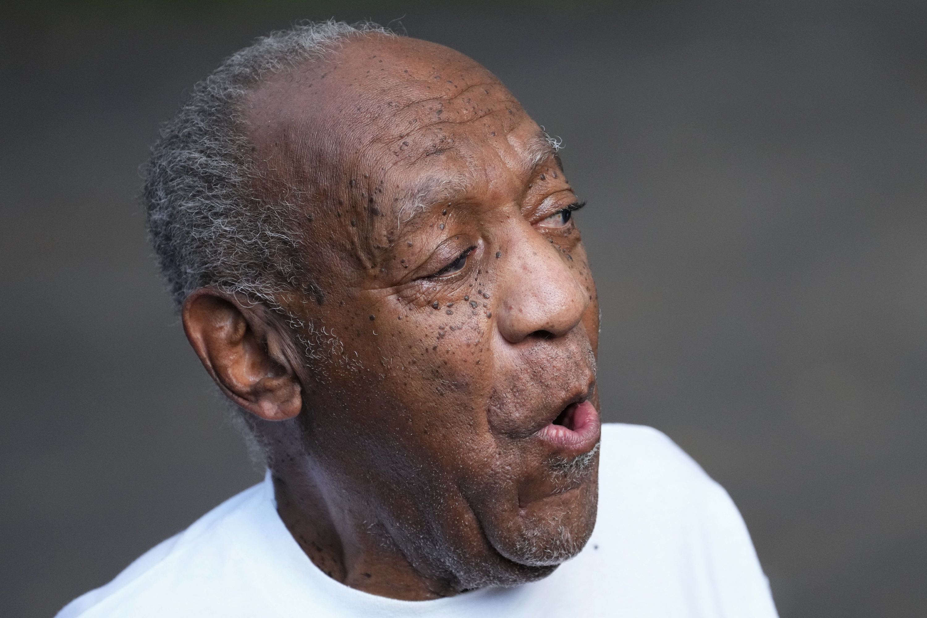 Bill Cosby reacts outside his home in Elkins Park, Pa., Wednesday, June 30, 2021, after being released from prison. Pennsylvania's highest court has overturned comedian Cosby's sex assault conviction. The court said Wednesday, that they found an agreement with a previous prosecutor prevented him from being charged in the case. The 83-year-old Cosby had served more than two years at the state prison near Philadelphia and was released. (AP Photo/Matt Slocum)