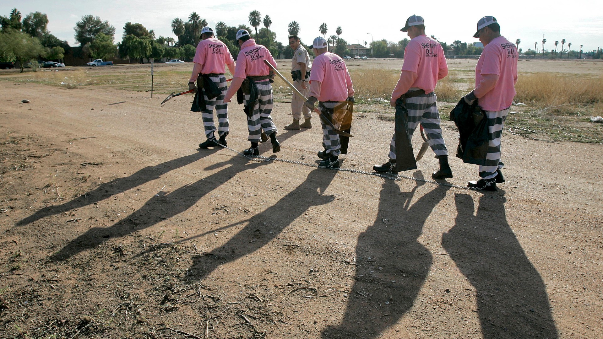 In this Dec. 11, 2007, file photo, members of the Maricopa County DUI chain gang are escorted to their assignment in Phoenix. As the nation on Thursday, June 17, 2021 officially made Juneteenth a federal holiday, honoring when the last enslaved Black people learned they were free, lawmakers are reviving calls to end a loophole in the Constitution that has allowed another form of slavery to thrive. (AP Photo/Matt York, File)