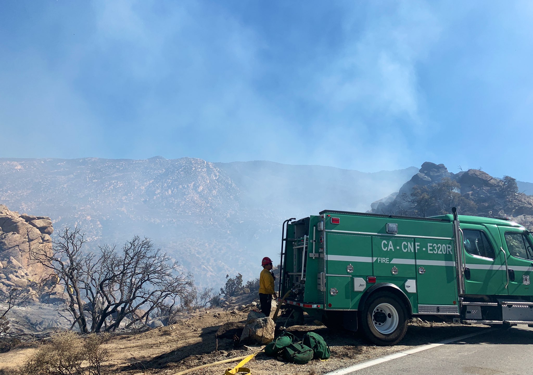 A firefighter standing next to a vehicle near the Flats Fire in Riverside County on June 14, 2021. (San Bernardino National Forest)