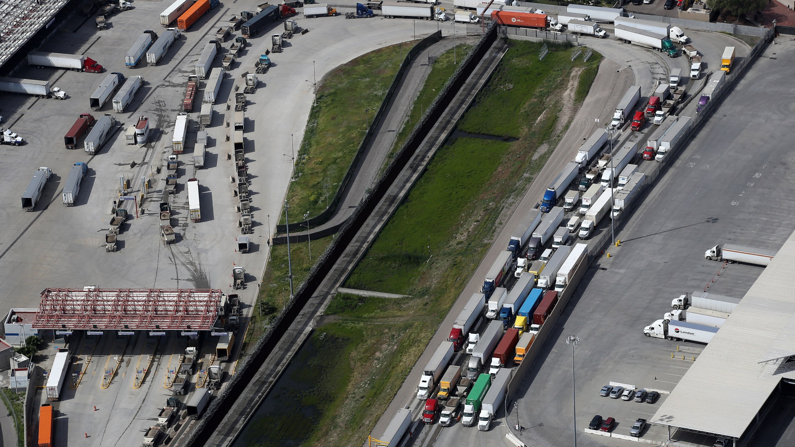 Commercial freight trucks line up to cross into the United States from Mexico through the U.S. Customs and Border Protection - Otay Mesa Port of Entry on March 20, 2020 in San Diego. (Sean M. Haffey/Getty Images)