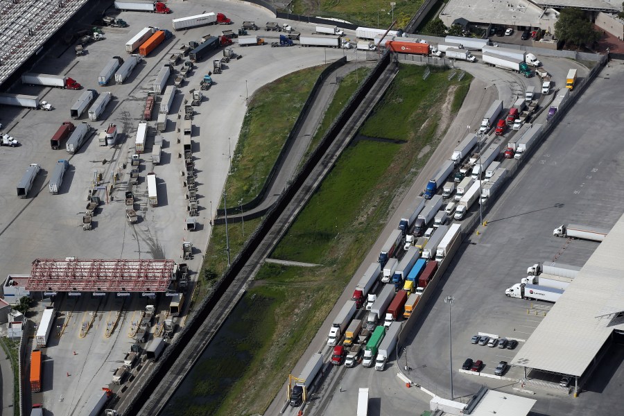 Commercial freight trucks line up to cross into the United States from Mexico through the U.S. Customs and Border Protection - Otay Mesa Port of Entry on March 20, 2020 in San Diego. (Sean M. Haffey/Getty Images)