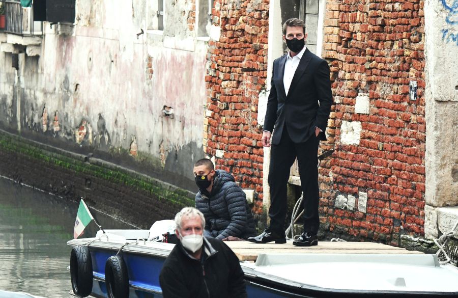 U.S. actor Tom Cruise stands on a boat during the shooting of the movie "Mission Impossible: Lybra" in Venice on Oct. 20, 2020. (ANDREA PATTARO / AFP via Getty Images)