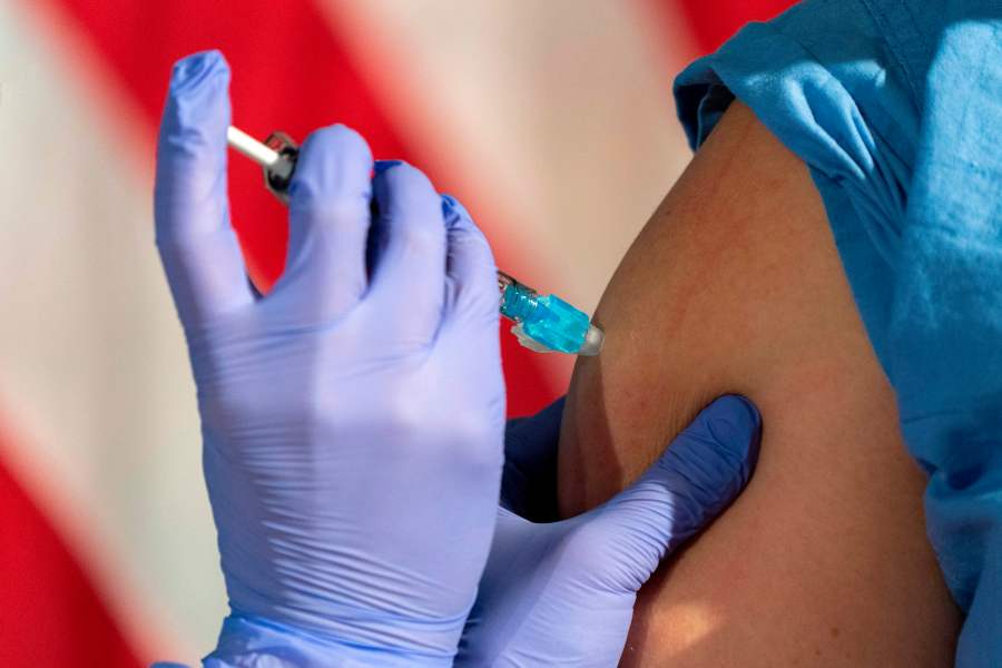 A nurse administers a COVID-19 vaccine on Dec.r 14, 2020, in Washington, DC. (JACQUELYN MARTIN/POOL/AFP via Getty Images)