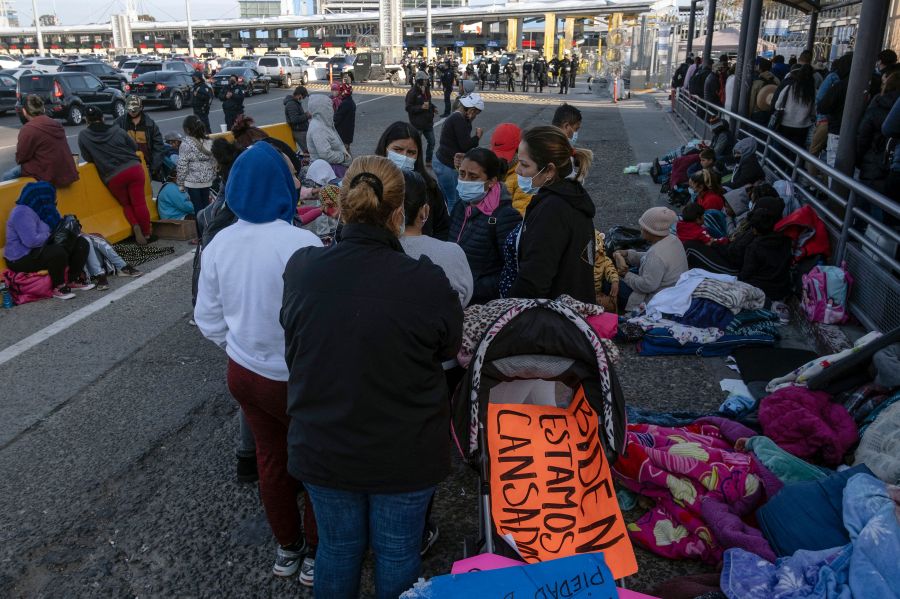 Migrants and asylum seekers are seen after spending the night in one of the car lanes off the San Ysidro Crossing Port on the Mexican side of the US_Mexico border in Tijuana, Baja California state, Mexico on April 24, 2021. (Guillermo Arias / AFP via Getty Images)