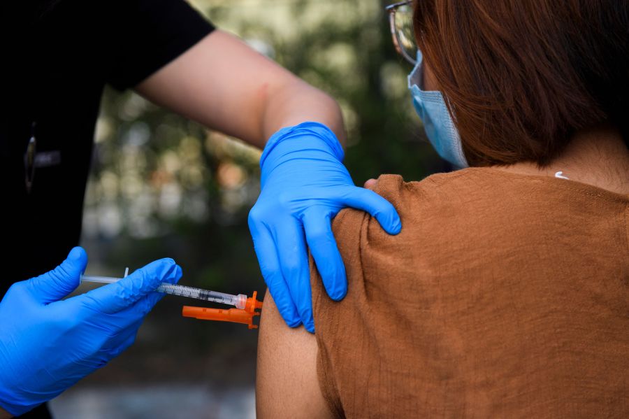 A teenager receives a first dose of the Pfizer COVID-19 vaccine in East Los Angeles YMCA on May 14, 2021. (PATRICK T. FALLON/AFP via Getty Images)