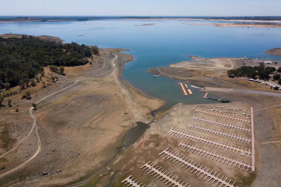 This aerial image shows empty boat slips sitting on a dry lake bed at Folsom Lake Marina as the lake experiences lower water levels during the California drought emergency on May 27, 2021 in El Dorado Hills. ( PATRICK T. FALLON/AFP via Getty Images)