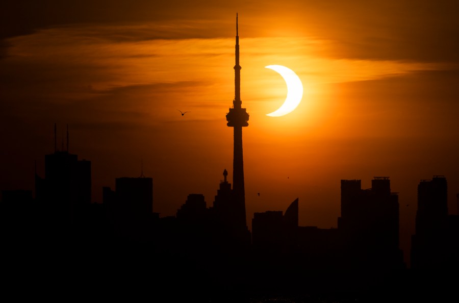 The sun rises behind the skyline during an annular eclipse on June 10, 2021 in Toronto, Canada. (Mark Blinch/Getty Images)