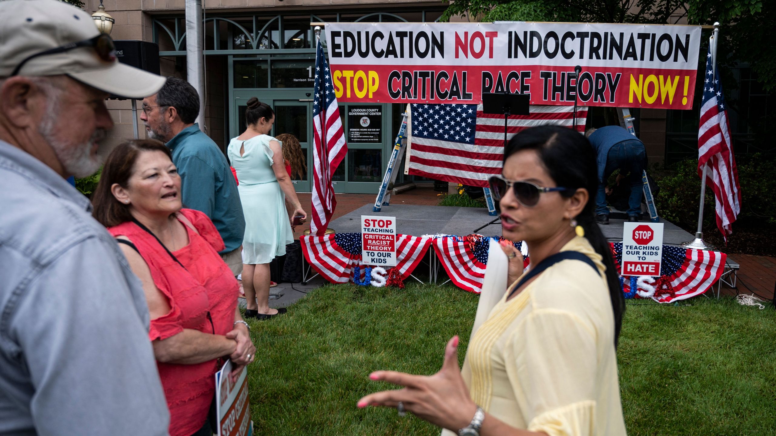 People talk before the start of a rally against "critical race theory" (CRT) being taught in schools at the Loudoun County Government center in Leesburg, Virginia on June 12, 2021. (ANDREW CABALLERO-REYNOLDS/AFP via Getty Images)