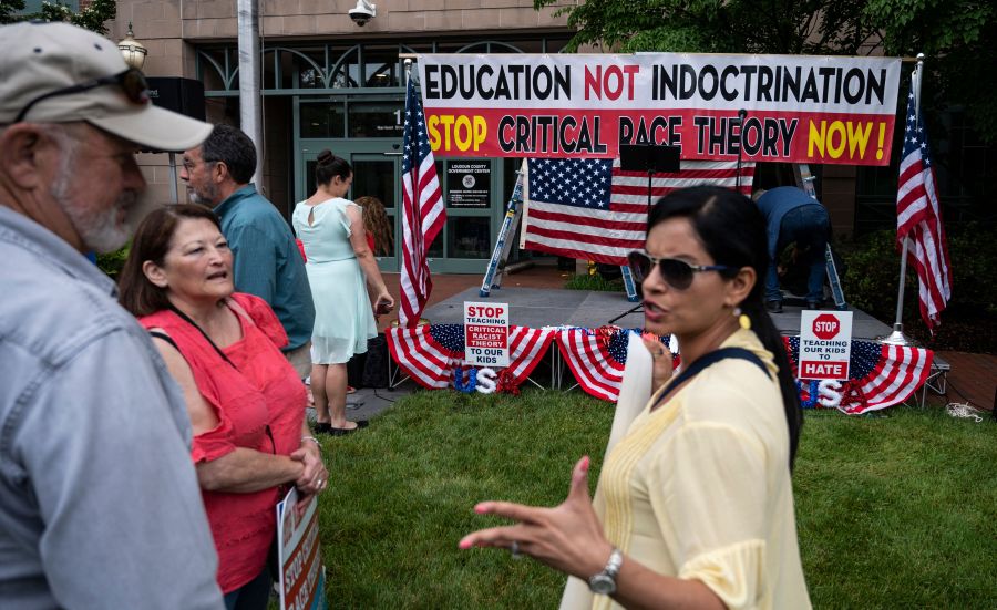 People talk before the start of a rally against "critical race theory" (CRT) being taught in schools at the Loudoun County Government center in Leesburg, Virginia on June 12, 2021. (ANDREW CABALLERO-REYNOLDS/AFP via Getty Images)