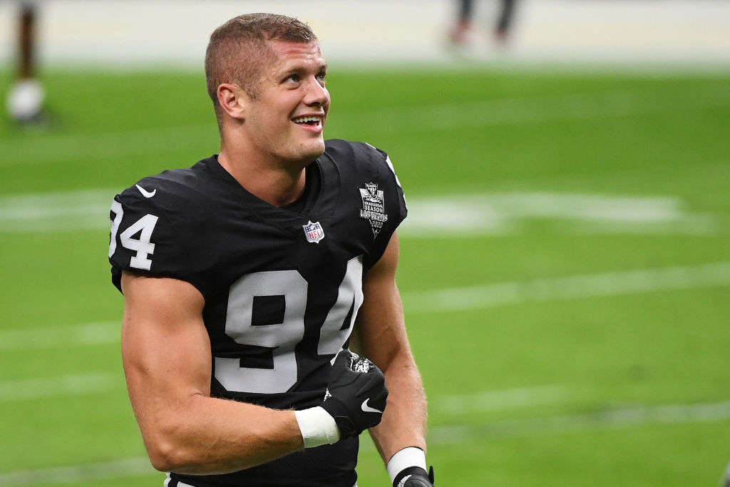 Carl Nassib of the Las Vegas Raiders flexes while smiling during warmups before a game against the Denver Broncos at Allegiant Stadium on Nov. 15, 2020 in Las Vegas, Nevada. (Ethan Miller/Getty Images)