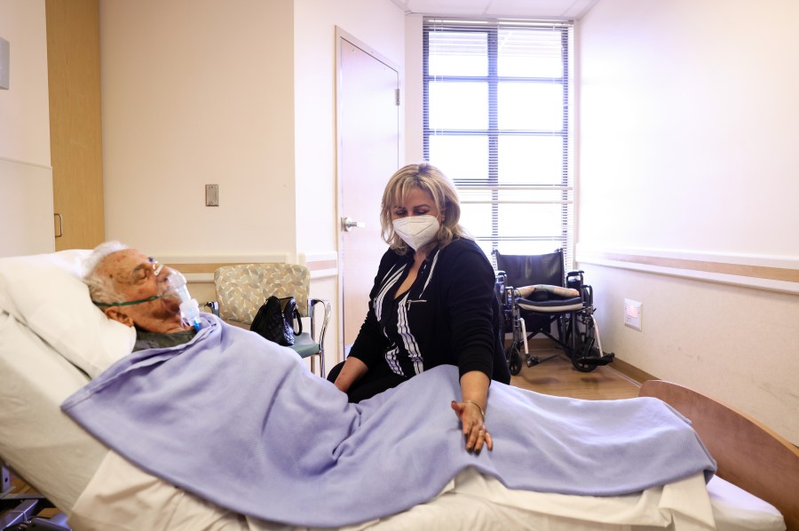 Resident Hanna Nasi is visited by daughter Surab Nasrallah on the first day of in-room family member visits at the Ararat Nursing Facility in the Mission Hills neighborhood on March 24, 2021 in Los Angeles, California. (Mario Tama/Getty Images)