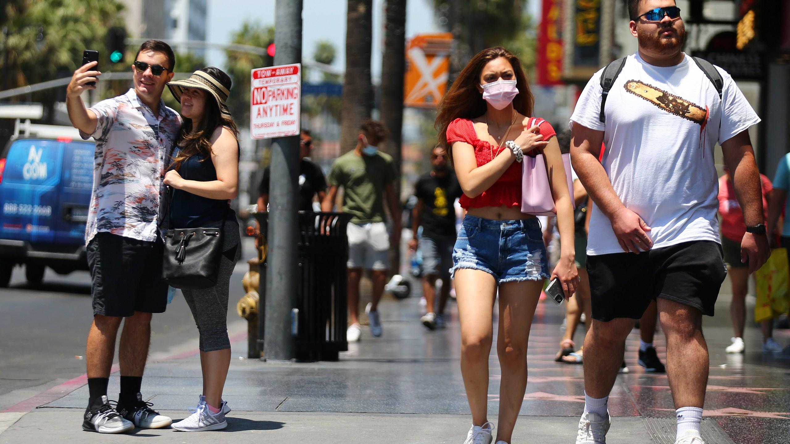 People walk and take photos on Hollywood Boulevard on June 15, 2021, in Los Angeles.(Mario Tama/Getty Images)