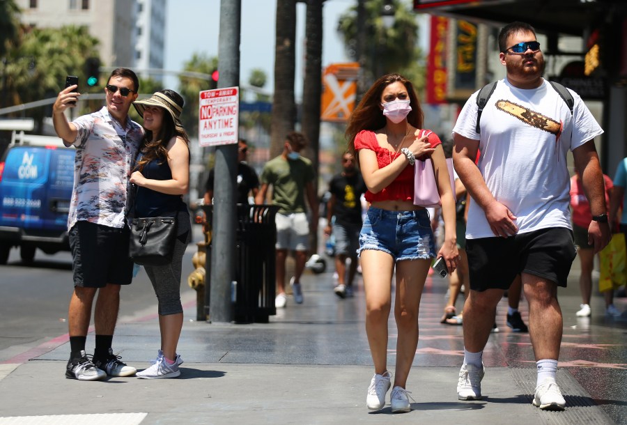 People walk and take photos on Hollywood Boulevard on June 15, 2021, in Los Angeles.(Mario Tama/Getty Images)