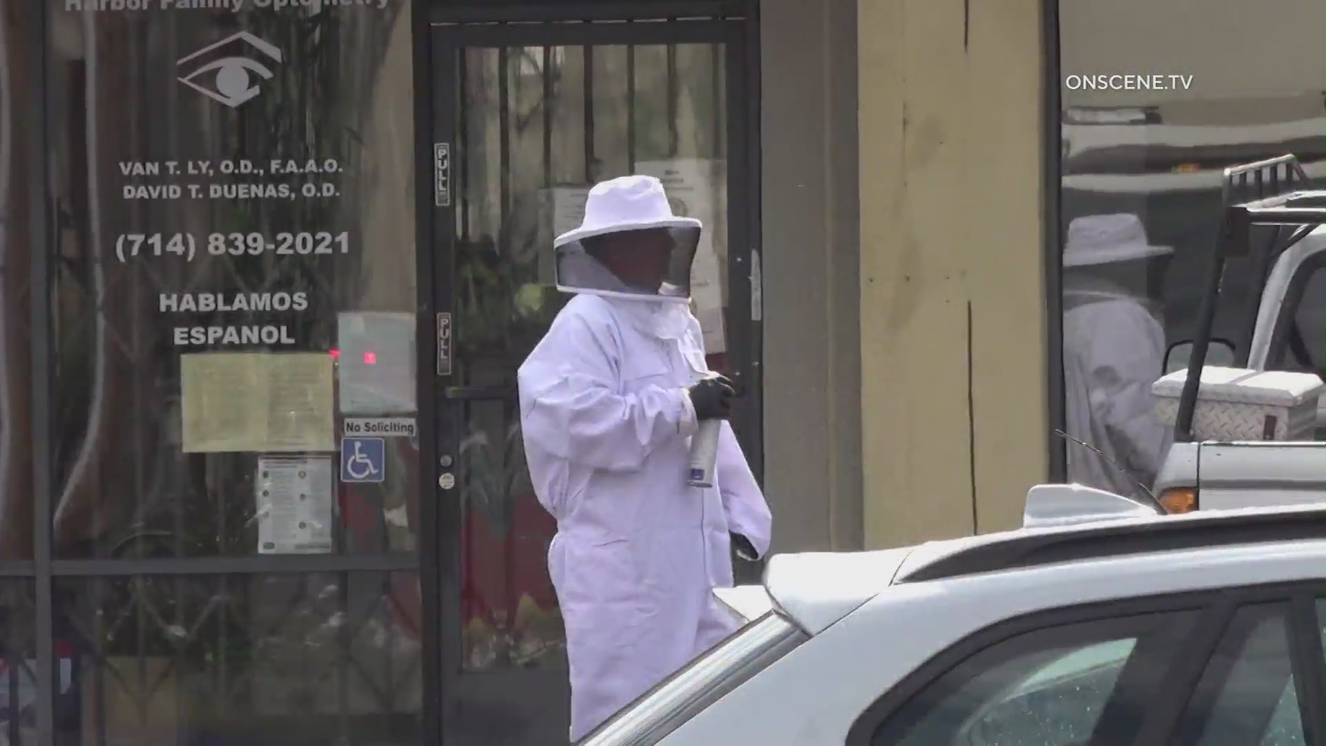 A person in a protective suit responds to a bee swarm in Fountain Valley on June 22, 2021. (OnSceneTV)