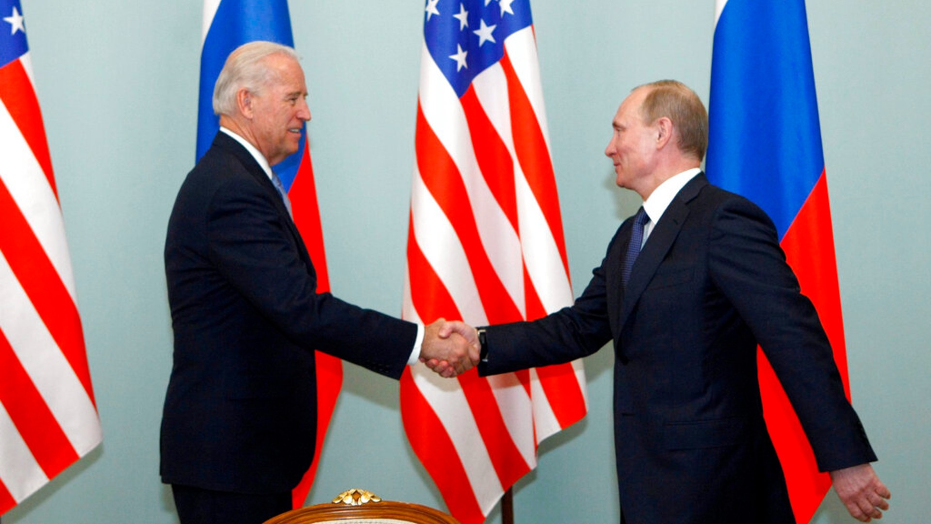 In this March 10, 2011 file photo, then U.S. Vice President Joe Biden, left, shakes hands with Russian Prime Minister Vladimir Putin in Moscow. (AP Photo/Alexander Zemlianichenko)