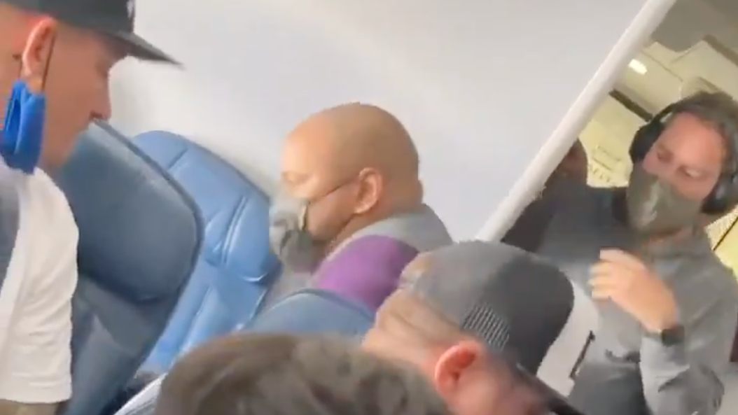 An unruly Delta Air Lines passenger is detained by passengers and crew members after allegedly attempting to breach the cockpit on a flight from Los Angeles on Nashville on June 4, 2021. (Jordan Suggs)