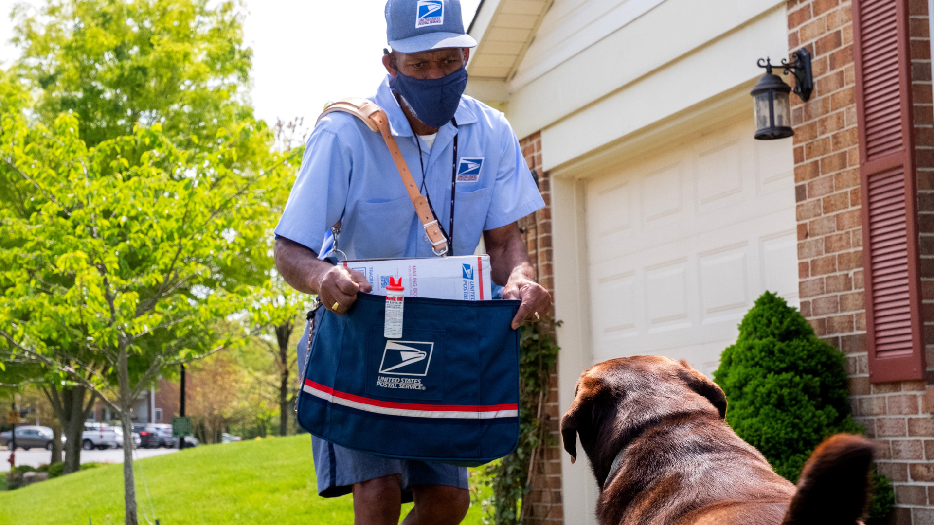 Letter carrier Thomas Tyler takes a protective stance against an approaching dog in Annapolis, Maryland in this undated photo provided by the USPS.