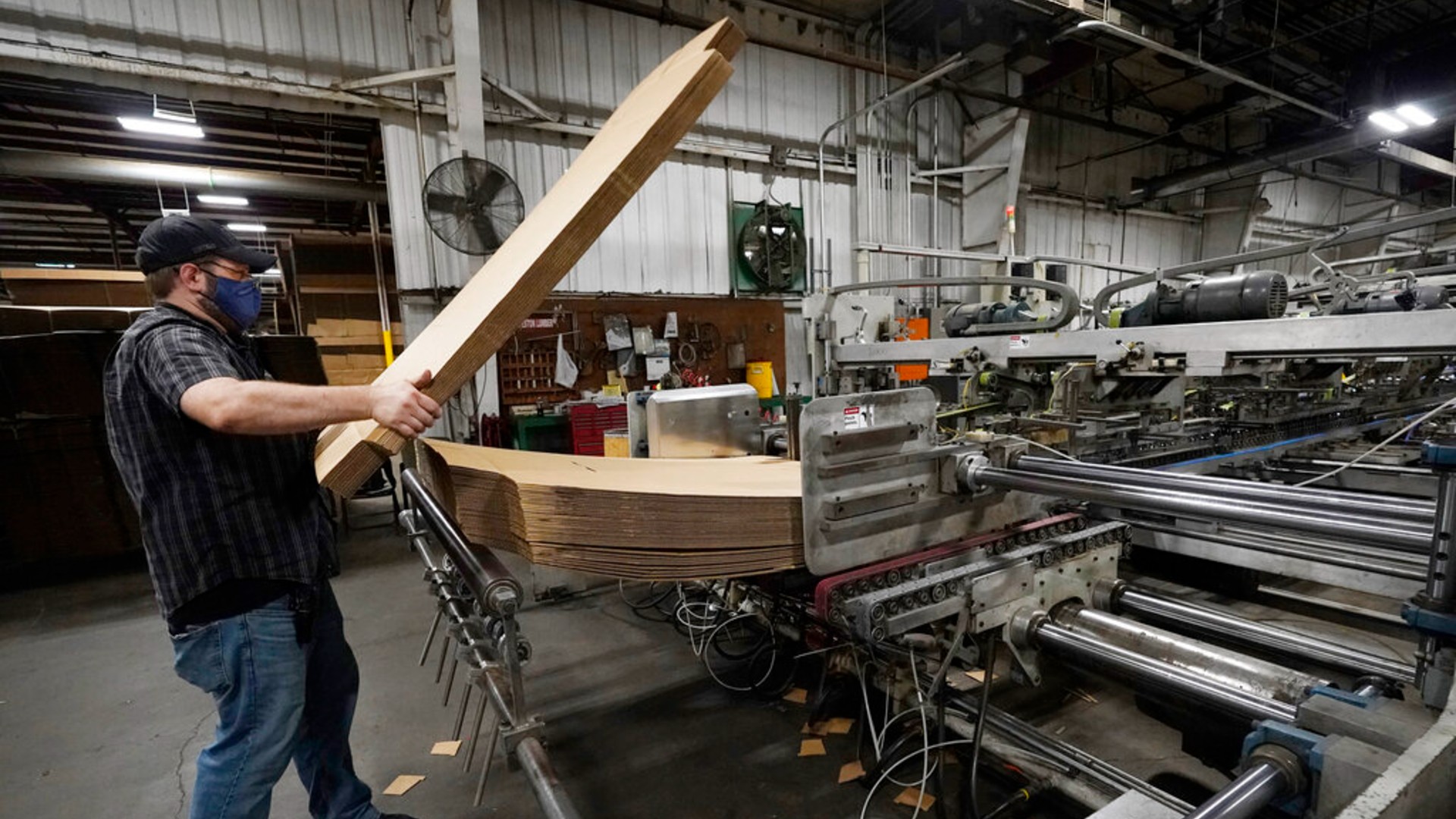 Rob Bondurant, a supervisor at Great Southern Industries, a packaging company, loads up a finishing machine in the Jackson, Miss., facility, Friday, May 28, 2021. (AP Photo/Rogelio V. Solis)