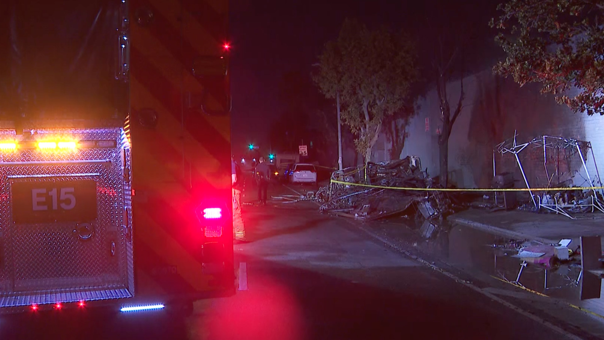 A recreational vehicle caught fire near a South Los Angeles homeless encampment on June 24, 2021. (KTLA)