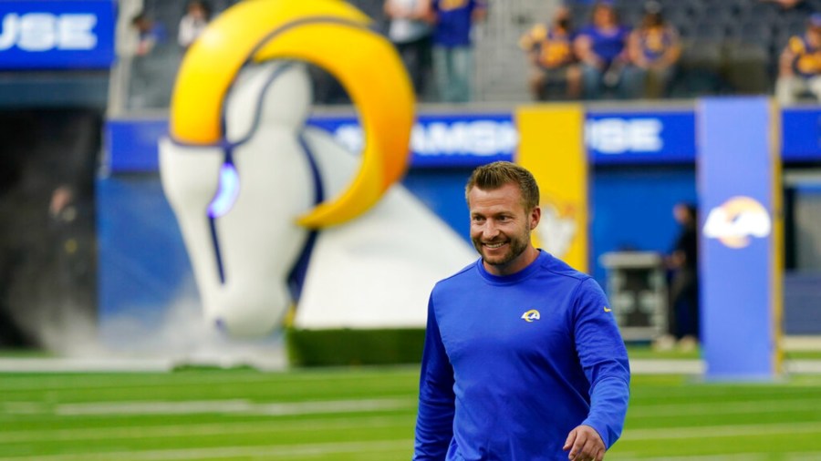 Los Angeles Rams head coach Sean McVay smiles as he walks on the field during NFL football camp Thursday, June 10, 2021, in Inglewood, Calif. (AP Photo/Marcio Jose Sanchez)