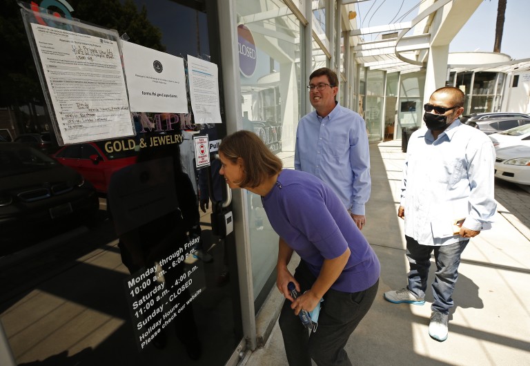 Joseph Ruiz, right, joins Jennifer Snitko and her husband Paul Snitko outside U.S. Private Vaults in Beverly Hills, where they rented safe deposit boxes, in an undated photo. The three are among more than a dozen customers suing the federal government to recover cash and valuables seized by the FBI. (Al Seib / Los Angeles Times)