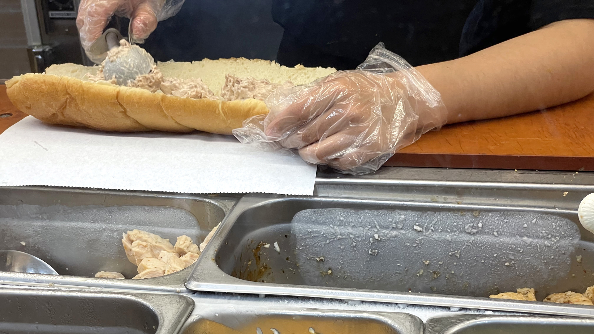 A worker at a Subway sandwich shop makes a tuna sandwich on June 22, 2021 in San Anselmo, California. A recent lab analysis of tuna used in Subway sandwiches commissioned by the New York Times did not reveal any tuna DNA in samples taken from Subway tuna sandwiches. The lab was unable to pinpoint a species in the tuna samples from three Los Angeles area Subway sandwich shops. (Justin Sullivan/Getty Images)