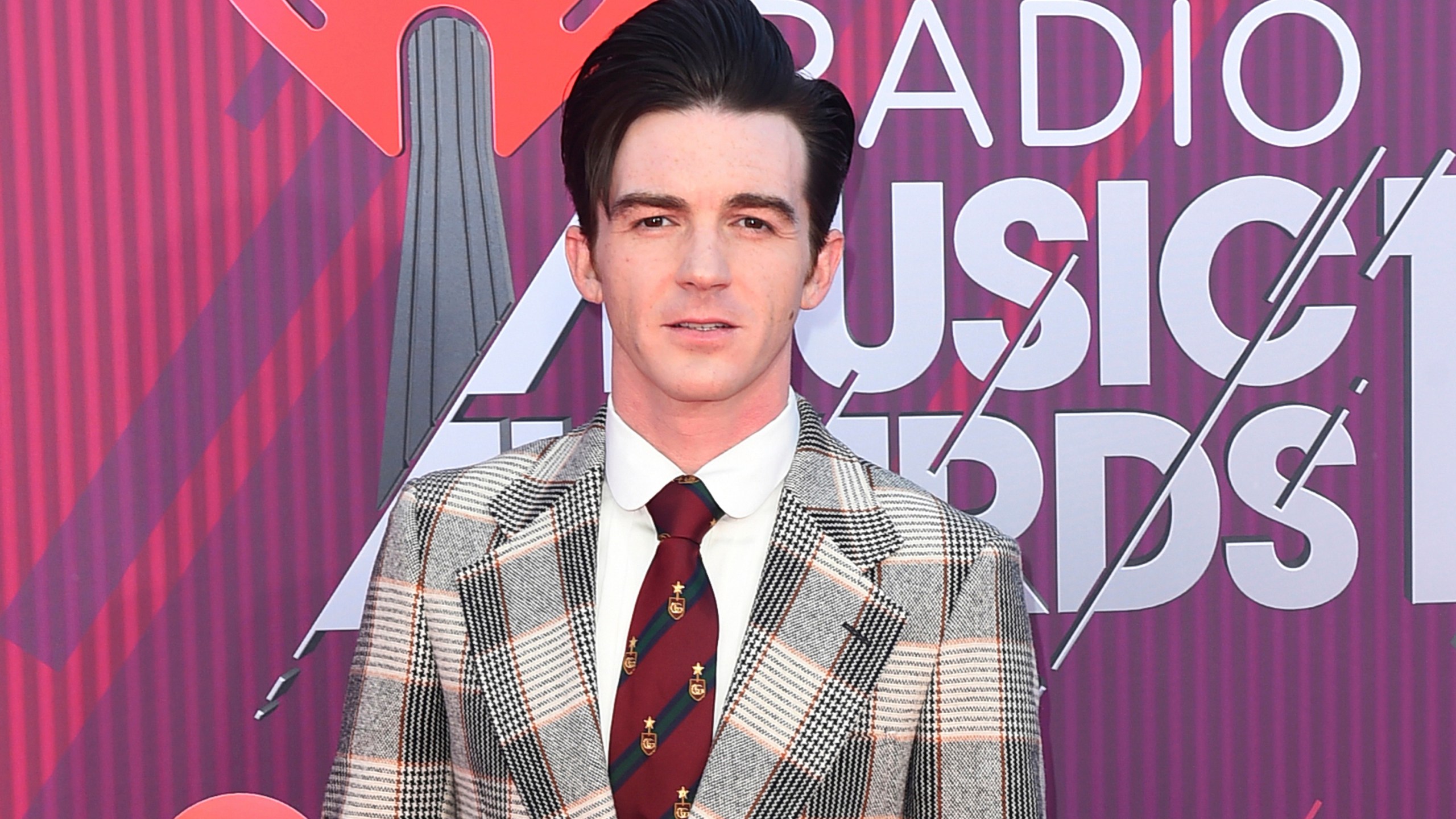 Drake Bell arrives at the iHeartRadio Music Awards on March 14, 2019, in Los Angeles. Bell, the former star of the popular Nickelodeon show “Drake & Josh,” pleaded guilty on Wednesday, June 23, 2021, to charges relating to a girl who met him online and attended one of his concerts in Cleveland in 2017, when she was 15. (Photo by Jordan Strauss/Invision/AP, File)