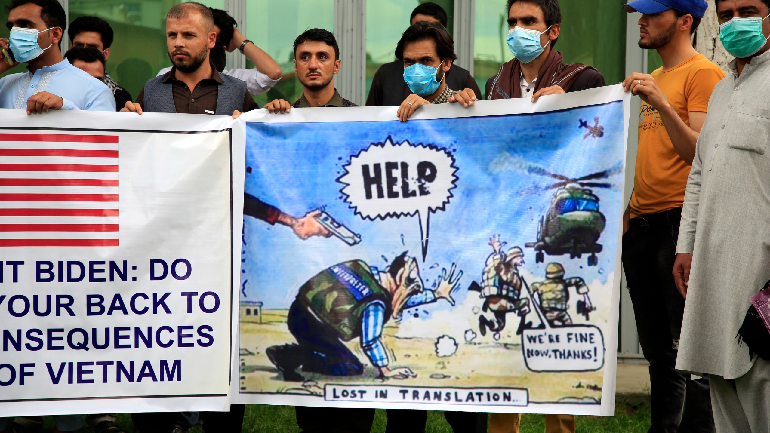 In this Friday, April 30, 2021, file photo former Afghan interpreters hold banners during a protest against the U.S. government and NATO in Kabul, Afghanistan. With American troops withdrawing from Afghanistan, pressure has been mounting for the Biden administration to plan a military evacuation of Afghans who supported U.S. military operations during two decades of war in their country. (AP Photo/Mariam Zuhaib,File)