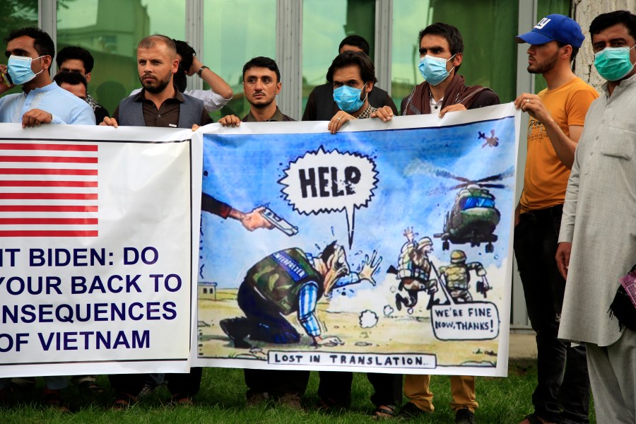 In this Friday, April 30, 2021, file photo former Afghan interpreters hold banners during a protest against the U.S. government and NATO in Kabul, Afghanistan. With American troops withdrawing from Afghanistan, pressure has been mounting for the Biden administration to plan a military evacuation of Afghans who supported U.S. military operations during two decades of war in their country. (AP Photo/Mariam Zuhaib,File)