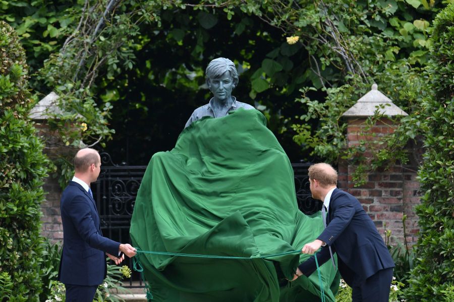 Britain's Prince William, left and Prince Harry unveil a statue they commissioned of their mother Princess Diana,  on what woud have been her 60th birthday, in the Sunken Garden at Kensington Palace, London, Thursday July 1, 2021. (Dominic Lipinski /Pool Photo via AP)