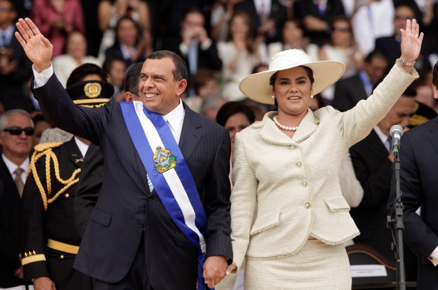 In this Jan. 27, 2010 file photo, wearing the presidential sash, Honduran President Porfirio Lobo and his wife First Lady Rosa Elena wave after Lobo was sworn in as the new president during his inauguration ceremony in Tegucigalpa. (AP Photo/Arnulfo Franco, File)