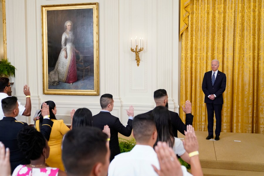 President Joe Biden listens as people take the Oath of Allegiance during a naturalization ceremony in the East Room of the White House, Friday, July 2, 2021, in Washington. (AP Photo/Patrick Semansky)