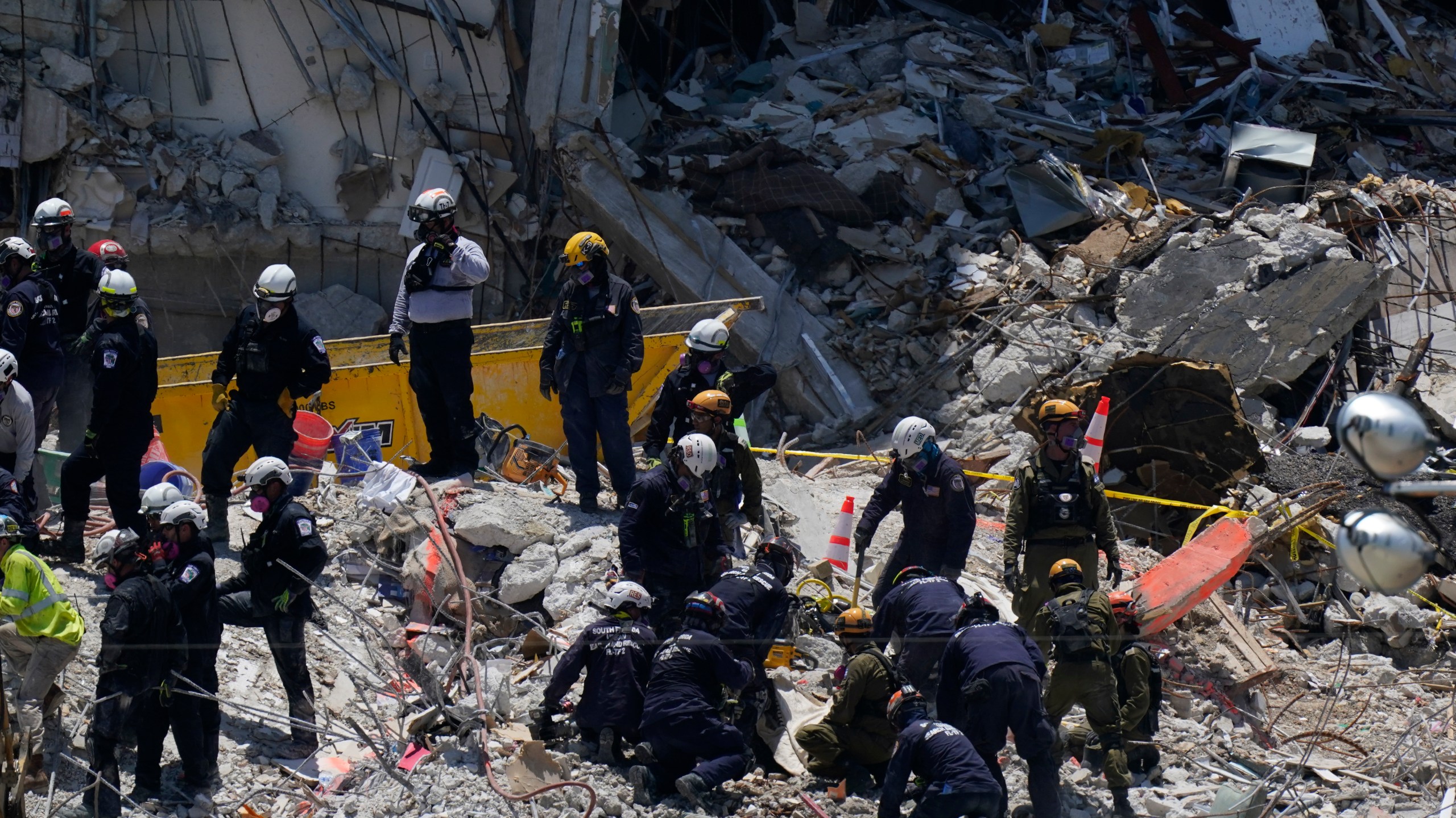 Search and rescue personnel work atop the rubble at the Champlain Towers South condo building, where scores of victims remain missing more than a week after it partially collapsed, Friday, July 2, 2021, in Surfside, Fla. (AP Photo/Mark Humphrey)