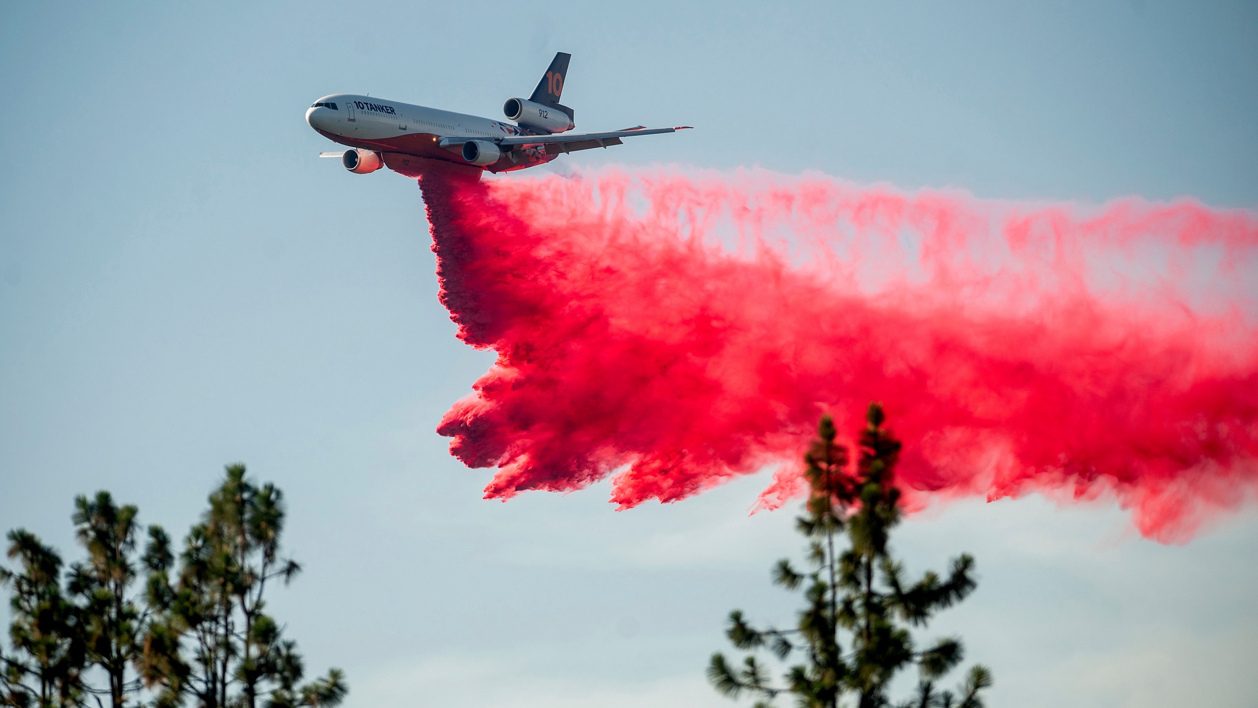 A DC-10 air tanker drops retardant while battling the Salt Fire near the Lakehead community of Unincorporated Shasta County, Calif., on Friday, July 2, 2021. (AP Photo/Noah Berger)