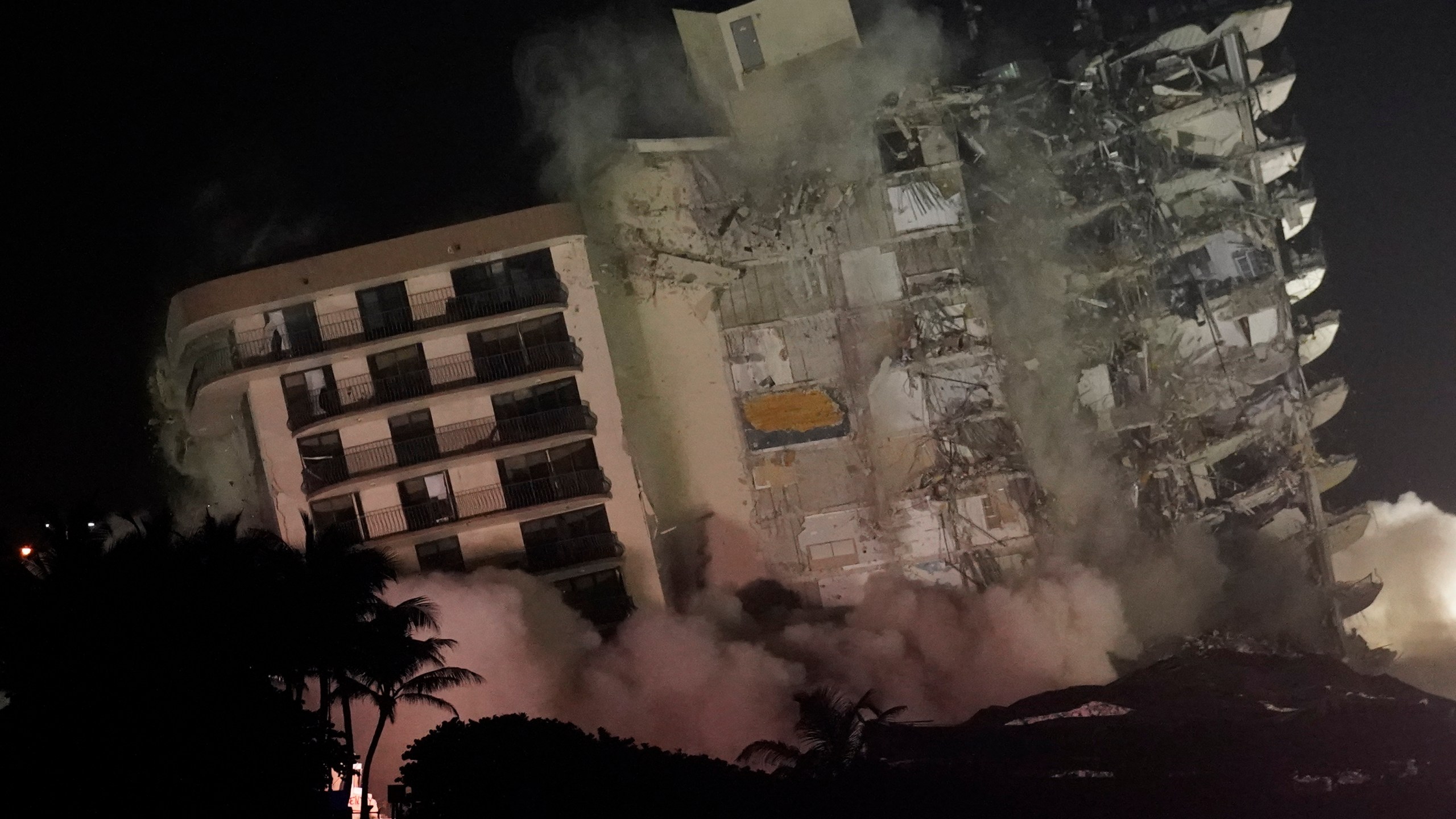 The damaged remaining structure at the Champlain Towers South condo building collapses in a controlled demolition, Sunday, July 4, 2021, in Surfside, Fla. The decision to demolish the Surfside building came after concerns mounted that the damaged structure was at risk of falling, endangering the crews below and preventing them from operating in some areas.(AP Photo/Lynne Sladky)