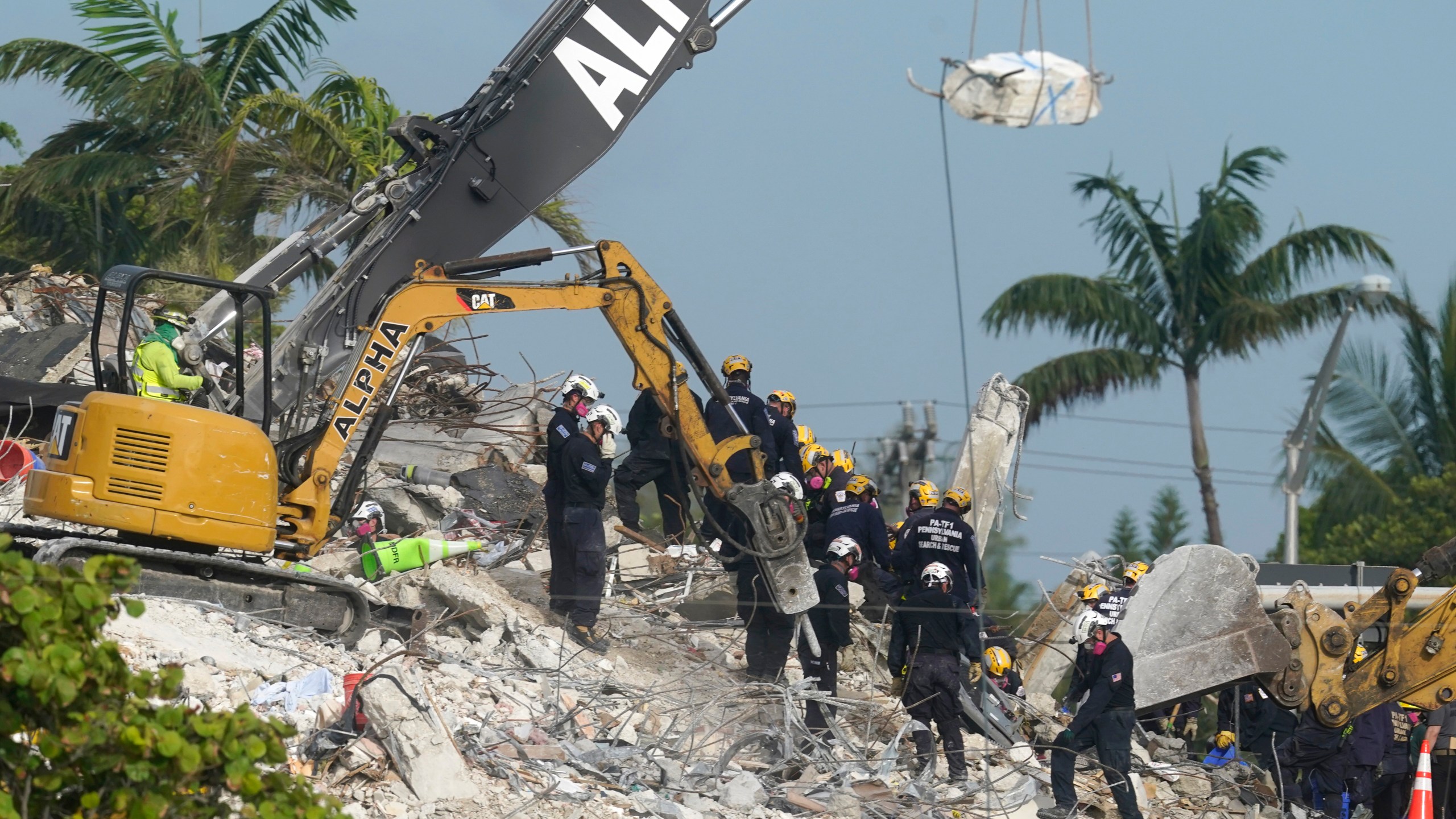 Rescue crews work at the site of the collapsed Champlain Towers South condo building after the remaining structure was demolished Sunday, in Surfside, Fla., Monday, July 5, 2021. Many people are unaccounted for in the rubble of the building which partially collapsed June 24. (AP Photo/Lynne Sladky)