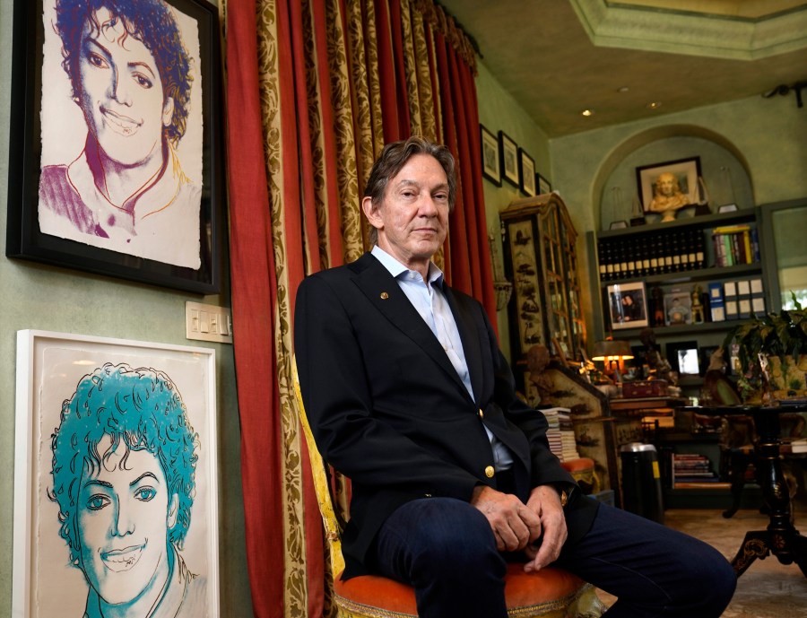 Entertainment lawyer and Michael Jackson Estate co-executor John Branca poses for a portrait alongside Andy Warhol prints of Jackson on July 8, 2021, at his home in Los Angeles. (Chris Pizzello/Associated Press)