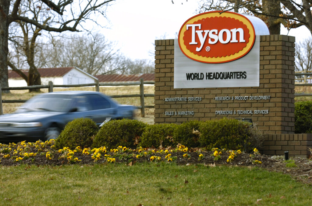 In this Jan. 29, 2006, file photo, a car passes in front of a Tyson Foods Inc., sign at Tyson headquarters in Springdale, Ark. (AP Photo/April L. Brown, File)