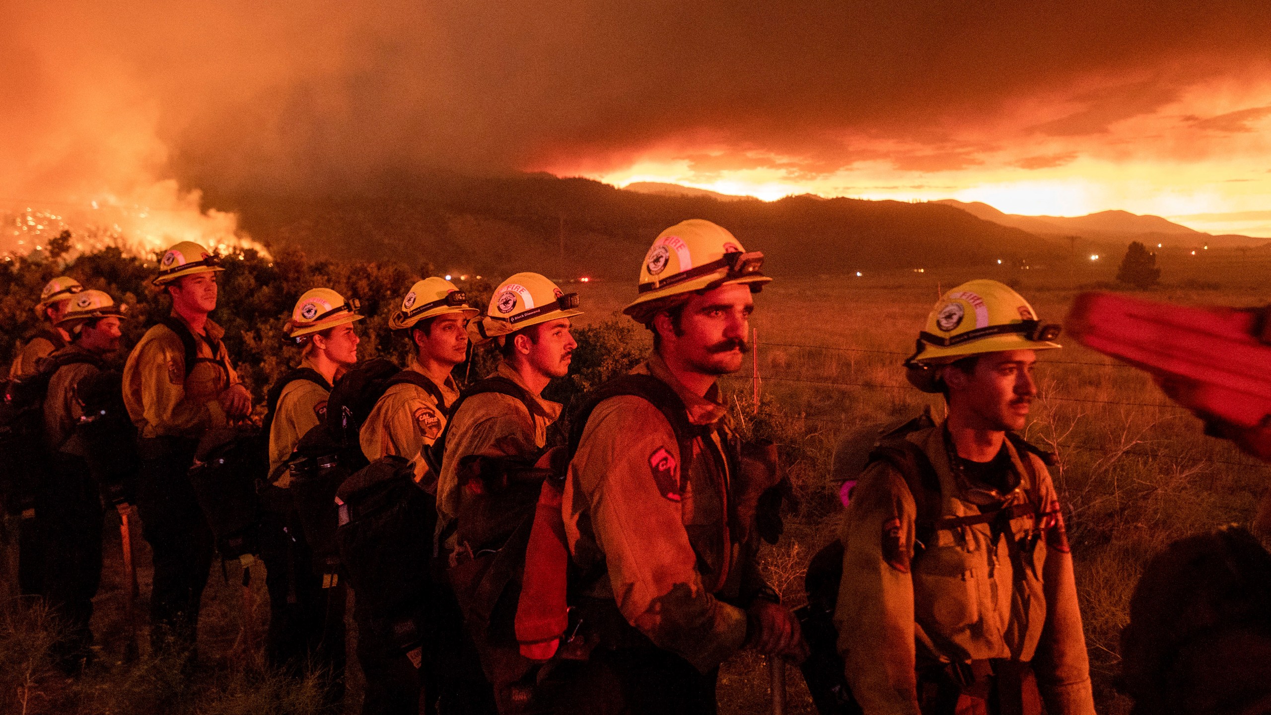 Firefighters from Cal Fire's Placerville station monitor the Sugar Fire, part of the Beckwourth Complex Fire, in Doyle, Calif., on Friday, July 9, 2021. (AP Photo/Noah Berger)