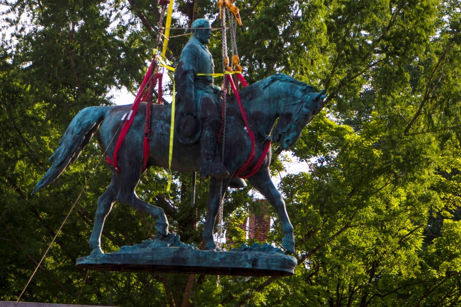 Workers remove the monument of Confederate General Robert E. Lee on Saturday, July 10, 2021 in Charlottesville, Va. (AP Photo/John C. Clark)