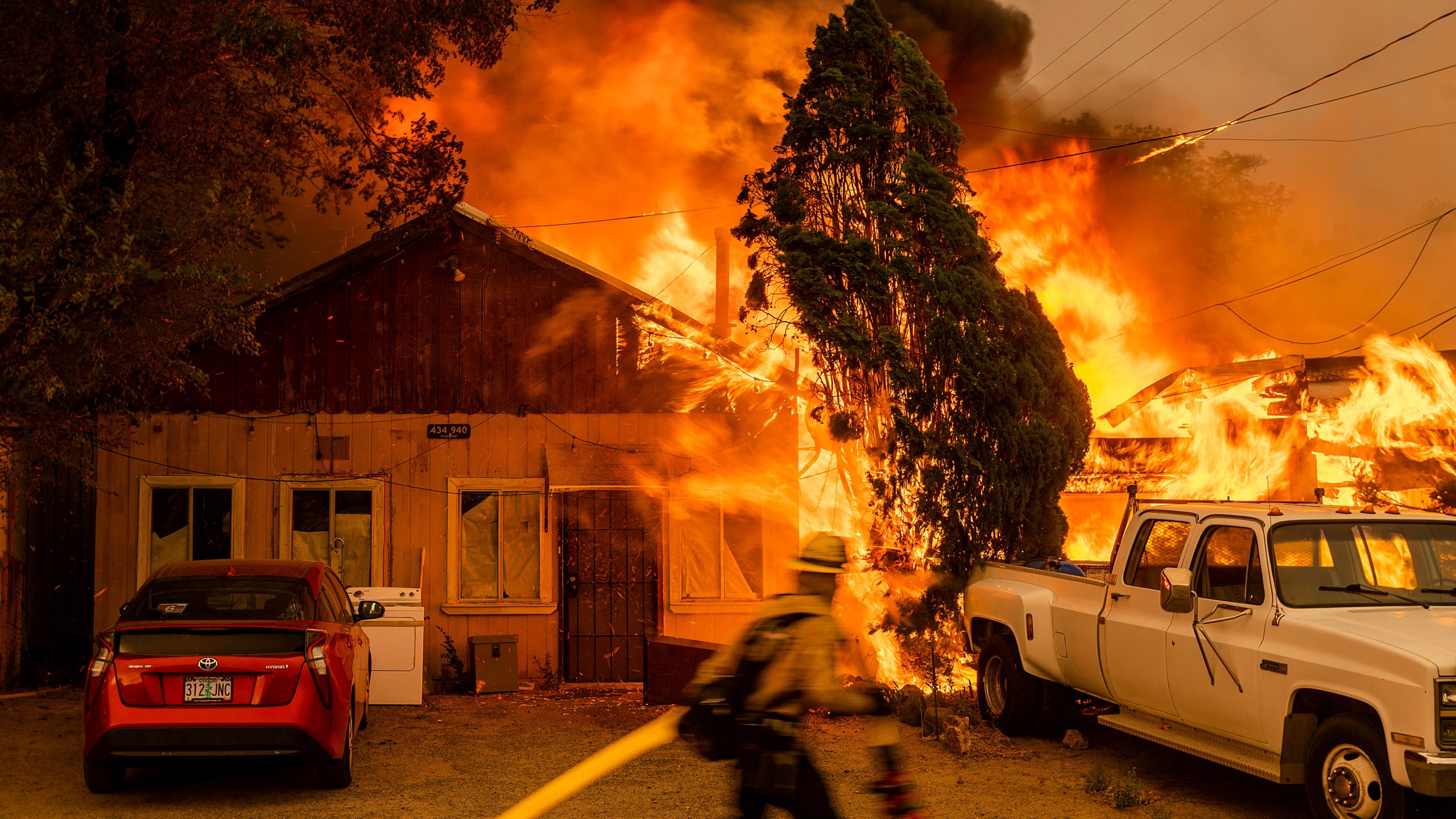 Fire consumes a home as the Sugar Fire, part of the Beckwourth Complex Fire, tears through Doyle, Calif., on Saturday, July 10, 2021. Pushed by heavy winds, the fire came out of the hills and destroyed multiple residences in central Doyle. (AP Photo/Noah Berger)